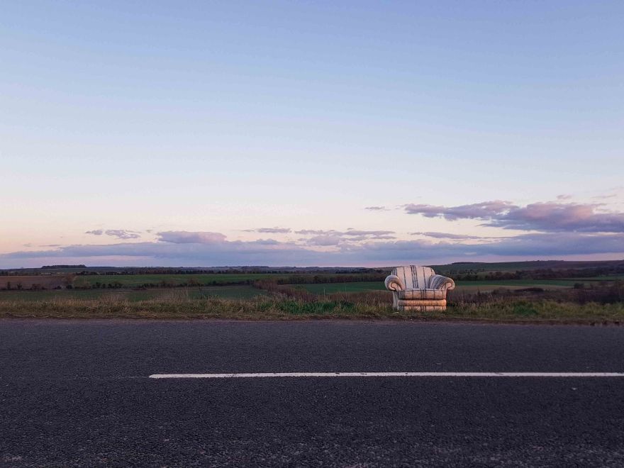 Abandoned Chair in front of a landscape background