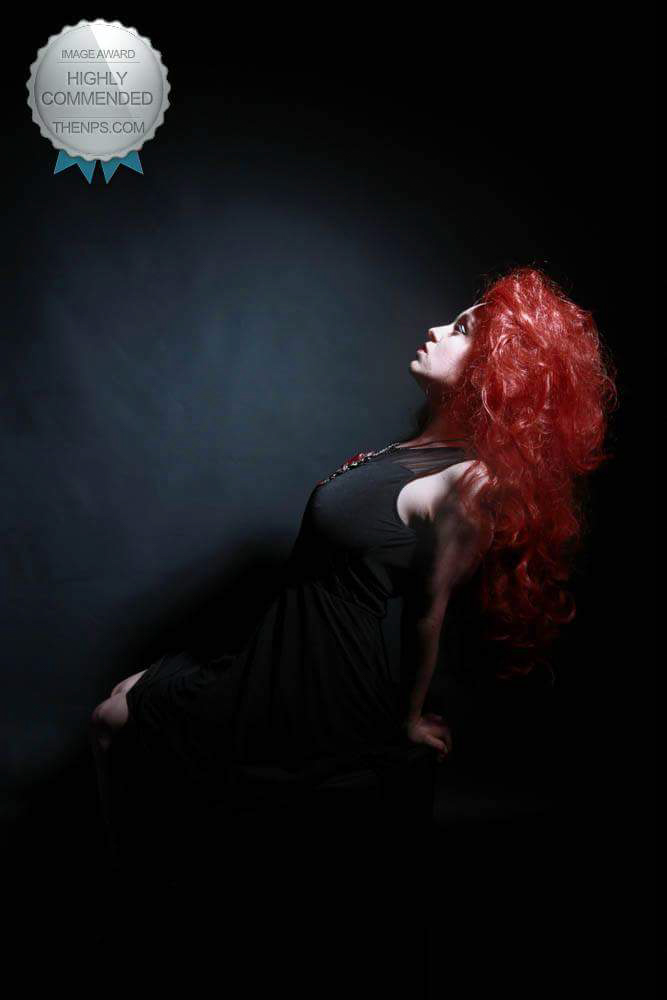 Red head portrait in low key studio portrait and edge lighting