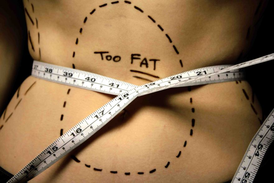 Body image of tape measure around stomach