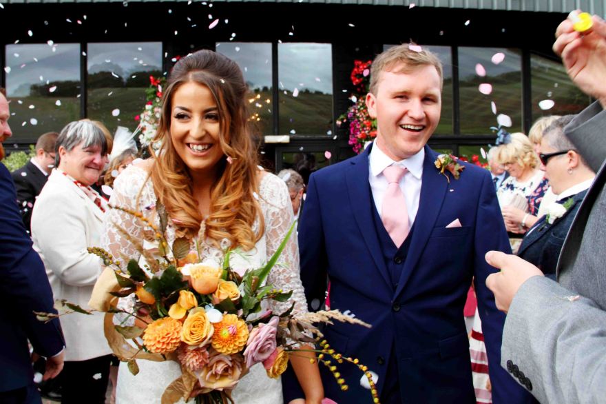 wedding portrait of bride and groom with confetti