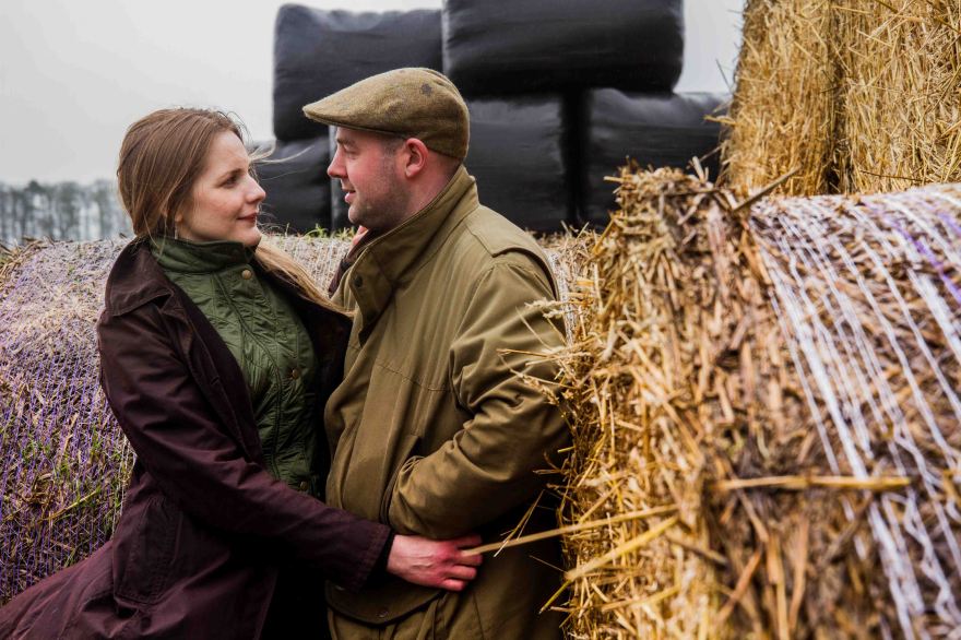Farmers wife and husband cuddling on the farm