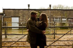 Couple cuddling in a barn