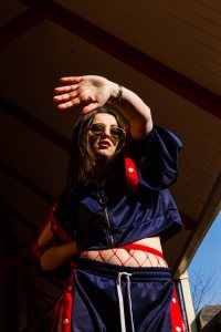 Natural light portrait of model on location with hand shielding the sun