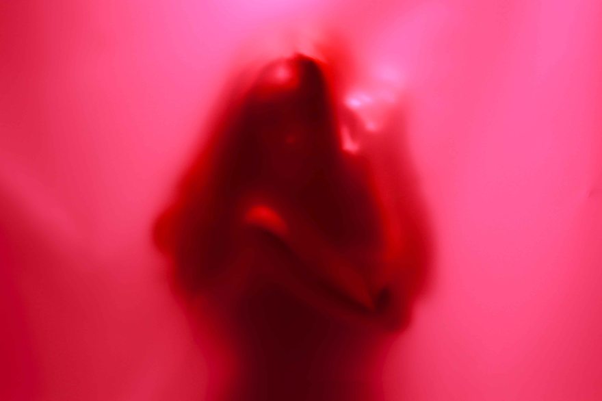 Pink Silhouette of woman holding herself