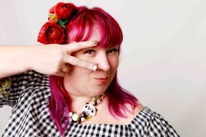Pink haired plus size model portrait in a studio