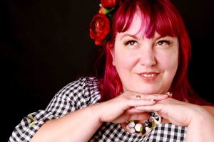 Plus size model portrait with pink hair and panda necklace