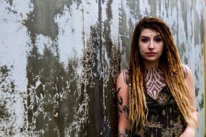rustic grey urban background and portrait of a model with dreadlocks