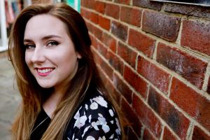 Close up portrait against a red brick