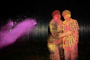 Powder paint being thrown at two men