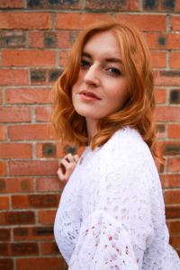 Ginger model portrait with brick backdrop