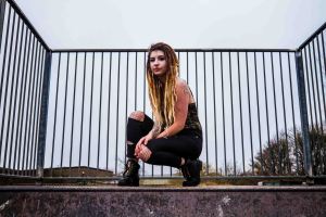 Portrait of model knelt in a skate park