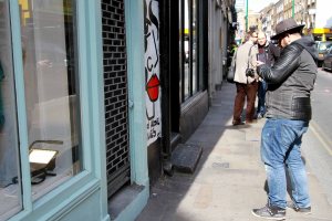 Man taking a photo in a street portrait