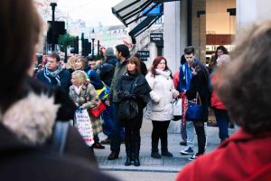 Street photography style portrait of a woman waiting to cross the road in london