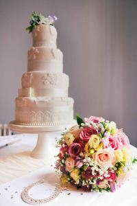 Tiered wedding cake with flowers in front