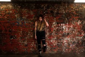 model with dreadlocks portrait with graffiti background