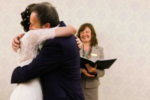 bride and groom hug as they are announced as husband and wife