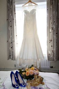 bride's wedding dress with bouquet and flowers