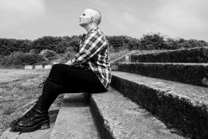 Black and white portrait of model sitting on steps