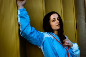 Brown haired model portrait in front of a yellow background