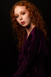 Side profile portrait of Gemma in purple gown