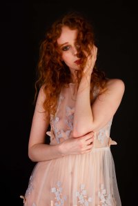 Red head model in sheer floaty butterfly dress in studio