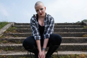 Bald model knelt in front of steps
