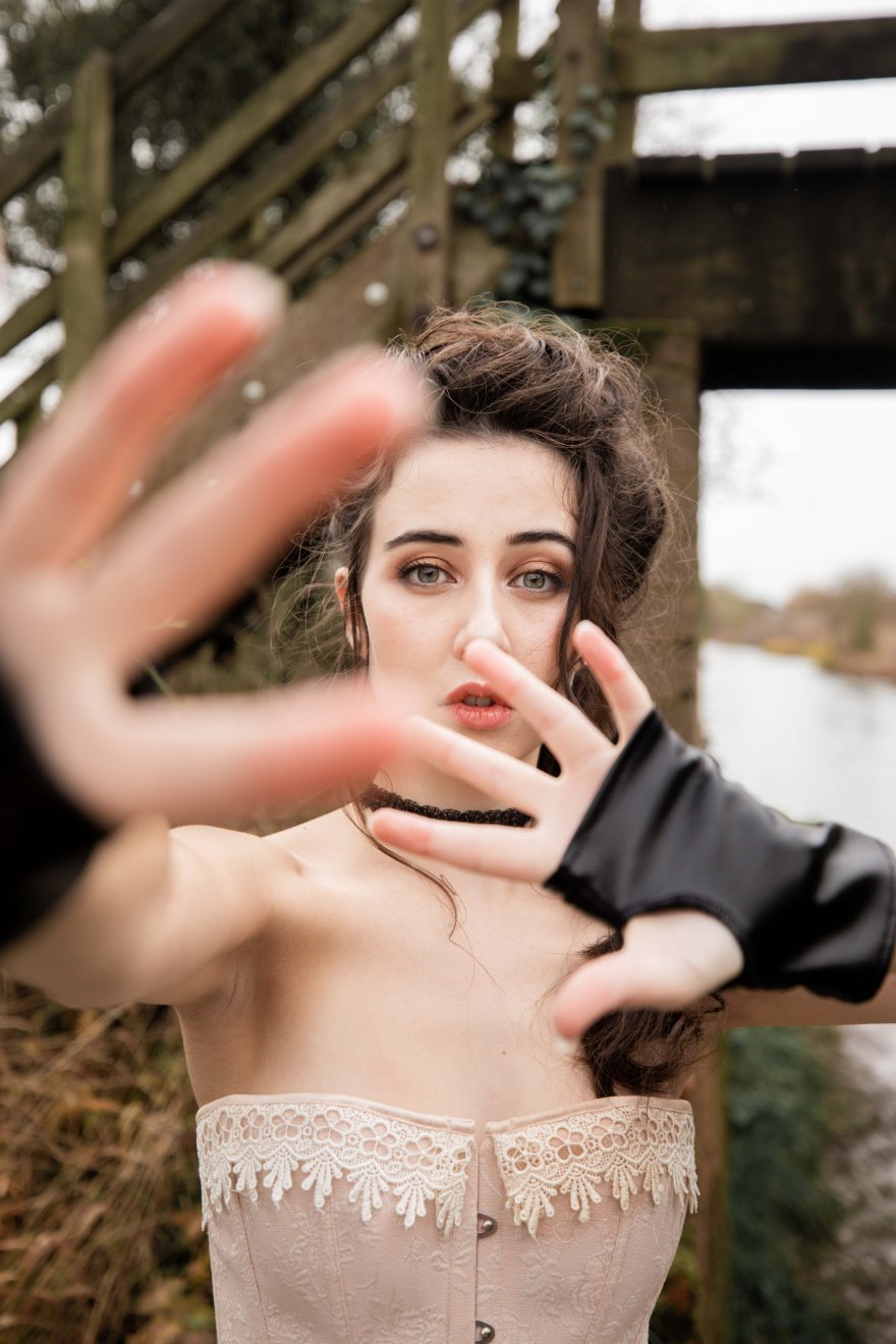 Portrait of model with hands in front of her face