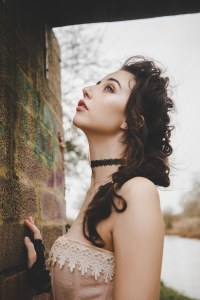 Brunette model side portrait with brick backdrop